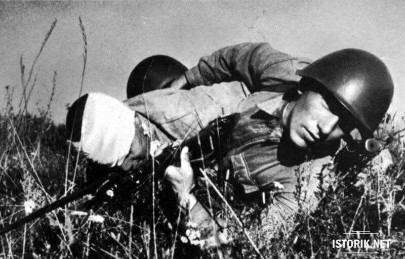 Солдат тащит раненого товарища, 1942
